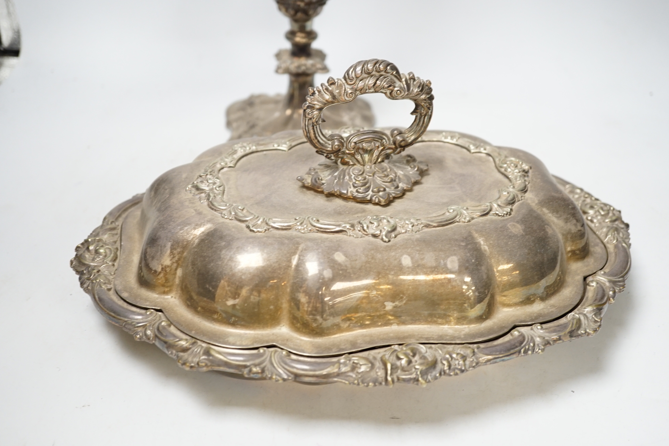 A silver plated entree dish and cover and a pair of three light candelabra, tallest 55cm